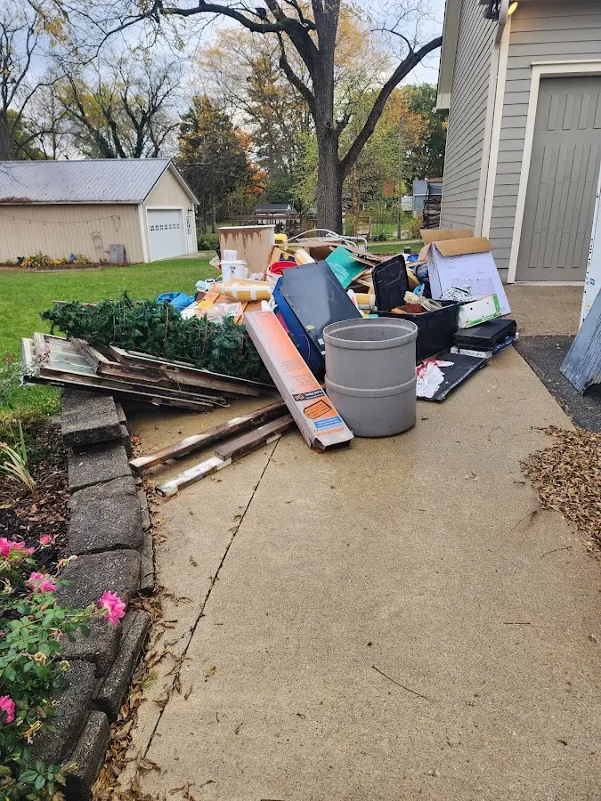Dumpster being loaded with debris for Estate Cleanout Dumpster Rental in Alamo Heights